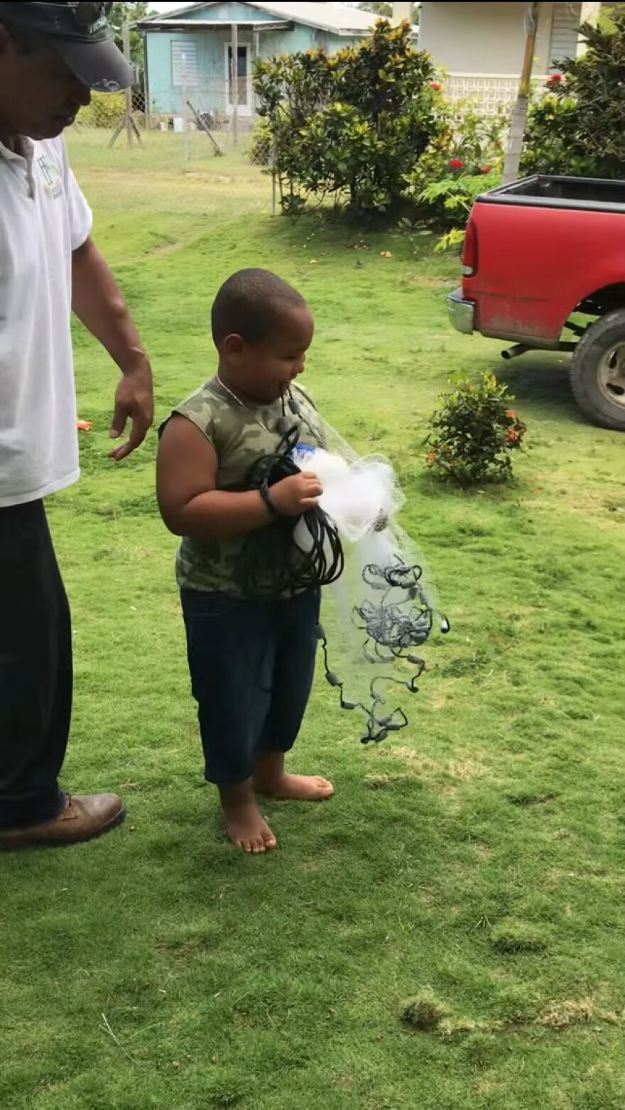 Jadriel “JJ” John learns from his late grandfather, Adriel Garcia, how to cast a 3-foot bait net at 6 years old on May 28, 2018.
