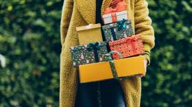 Someone holds a stack of holiday gifts. (Liliya Krueger)
