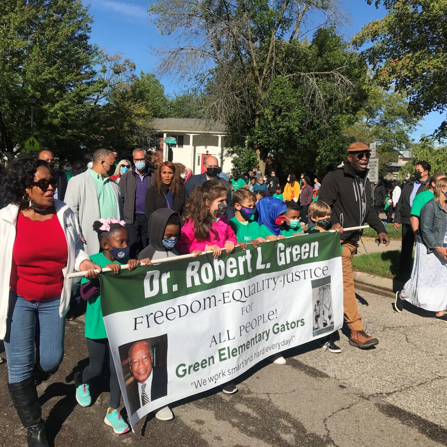 Elementary school students march behind civil rights rights activist Robert L. Green on Friday, Sept. 24, 2021 to the street where Green fought housing segregation in East Lansing in the 1960s.