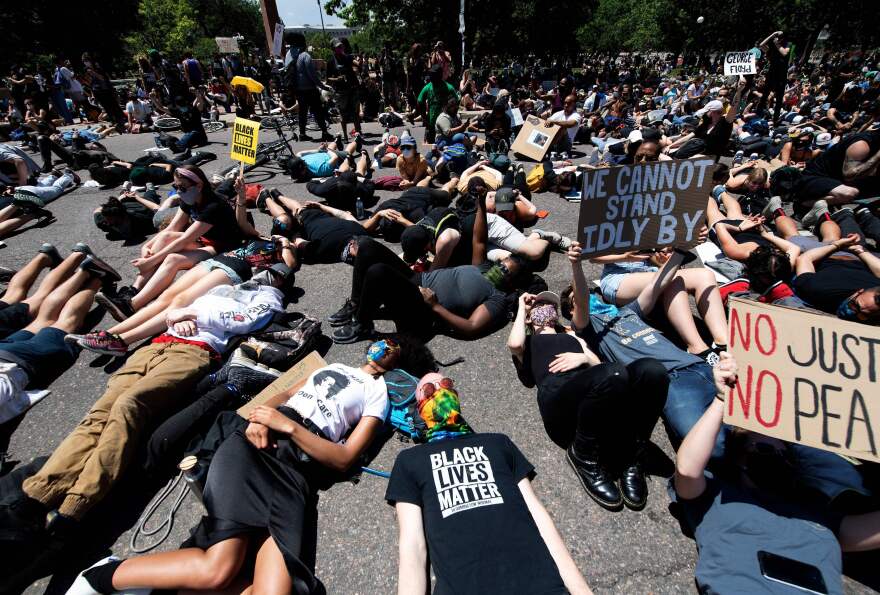 Demonstrators lie on the ground while yelling I can't breathe for nine minutes during a protest of the death of George Floyd in Denver on May 30, 2020.