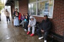 Thomas Lacy (right) is standing in line on that rainy Thursday morning, waiting for his turn inside the food pantry.