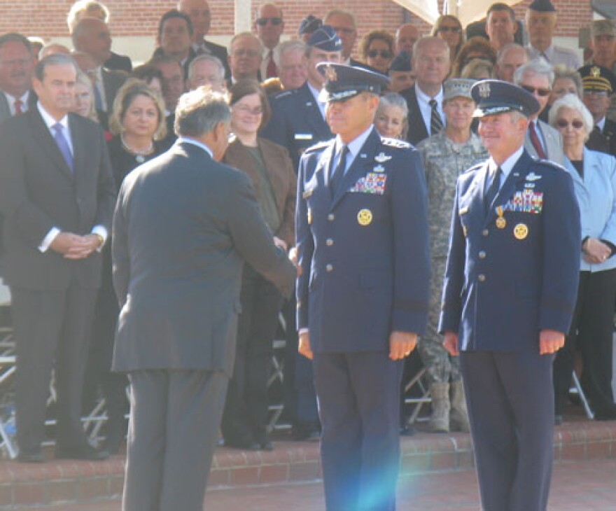 Defense Secretary Leon Panetta (L) shakes the hand of Gen. William Fraser (C) after Fraser assumed command of United States Transportation Command at Scott Air Force Base on Friday. Retiring Gen. Duncan McNabb is behind Fraser.