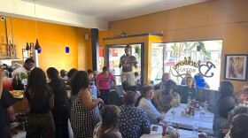 Tonisha Scott speaks about the importance of raising wages in Alameda County during Tuesday's celebration at the BlackBerry Cafe.