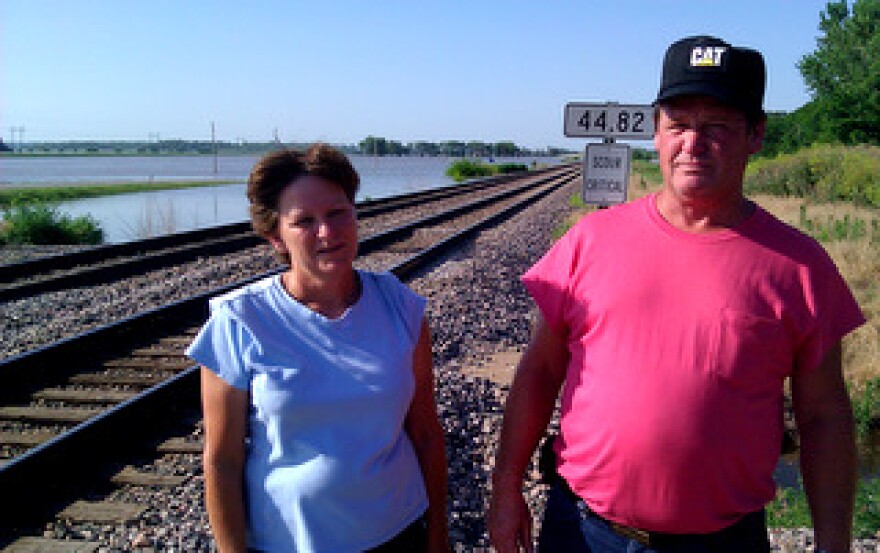 Tammy Dotson, Robert Servaes. Flood surrounded home in center background. Near Rushville, MO. (click to enlarge)