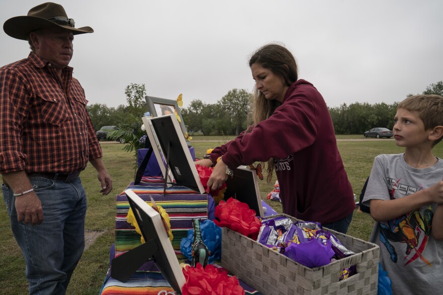 Christopher Seiler, who was Makenna Lee Elrod's stepfather, April Elrod, and her son Holden Elrod, 8, help decorate Makenna's altar.