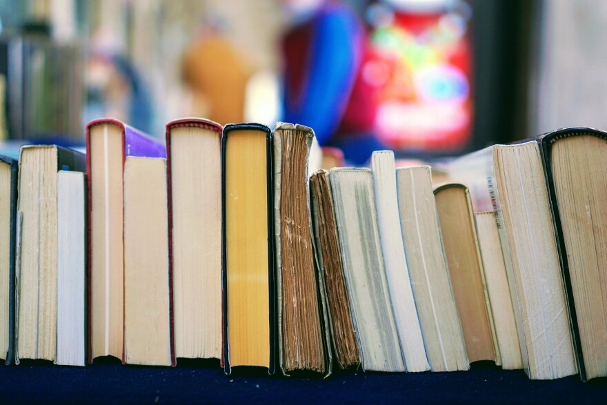 A row of books laid down so the pages are visible instead of the spines