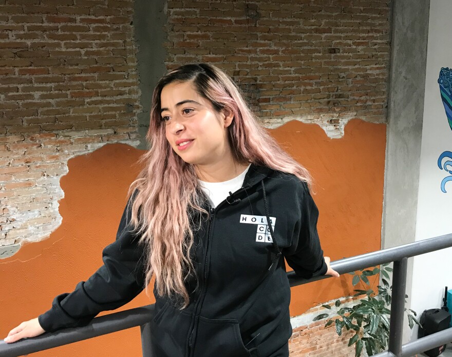 Marcela Torres poses for a portrait at Hola Code. In addition to software training, Hola Code provides meals, banking services, yoga classes and mental health support during its five-month program.