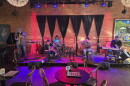 musicians on stage at UrbanBeat including a guitar player, a bass player, a piano player, a soporano saxophone player and a drummer.