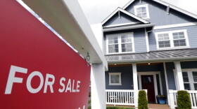 A "For Sale" sign stands in front of a home that is in the process of being sold in Monroe, Wash., outside of Seattle. (Elaine Thompson, File/AP Photo)