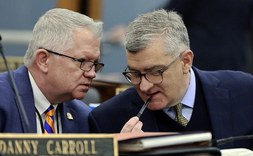 Sen. Danny Carroll (left), a Republican from Paducah, confers with Senate Majority Caucus Chair Robby Mills (right) after speaking on immigration before the chamber.