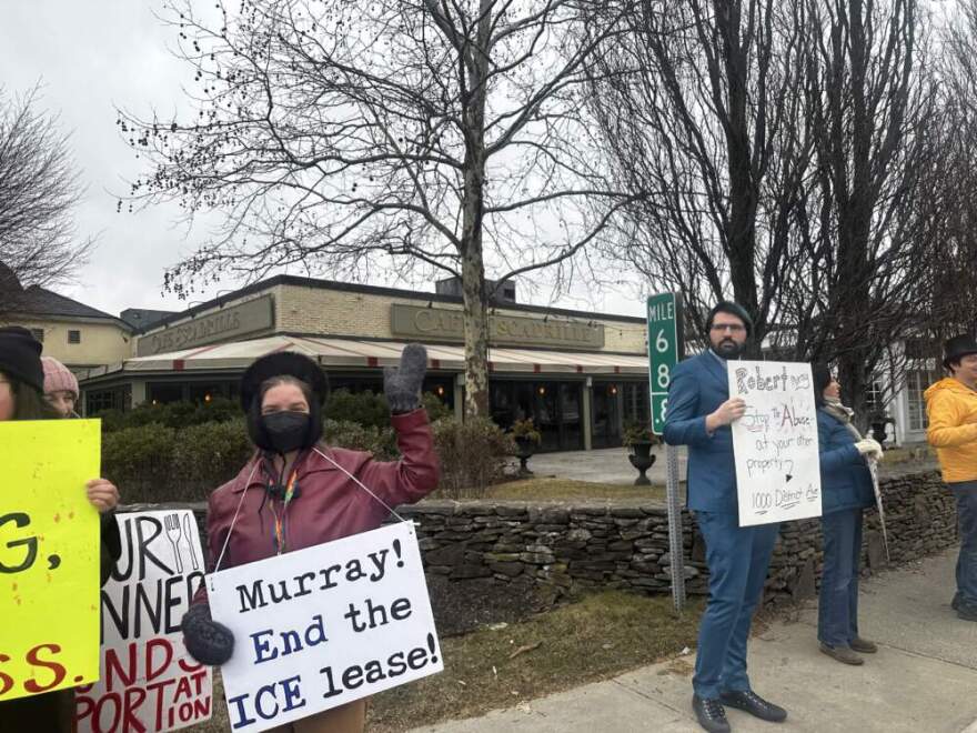 Alex Johnson, center left, was among those protesting at Cafe Escadrille. (Simón Rios/WBUR)