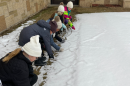 The students are bundled against the cold and are pointing to the tunnels.