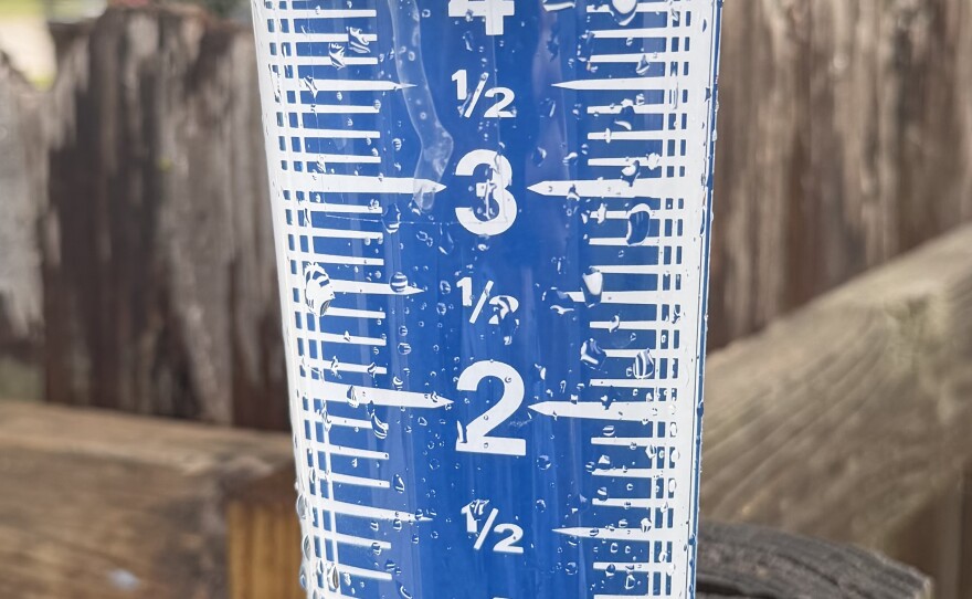A rain gauge showing rainfall of about 4.75 inches