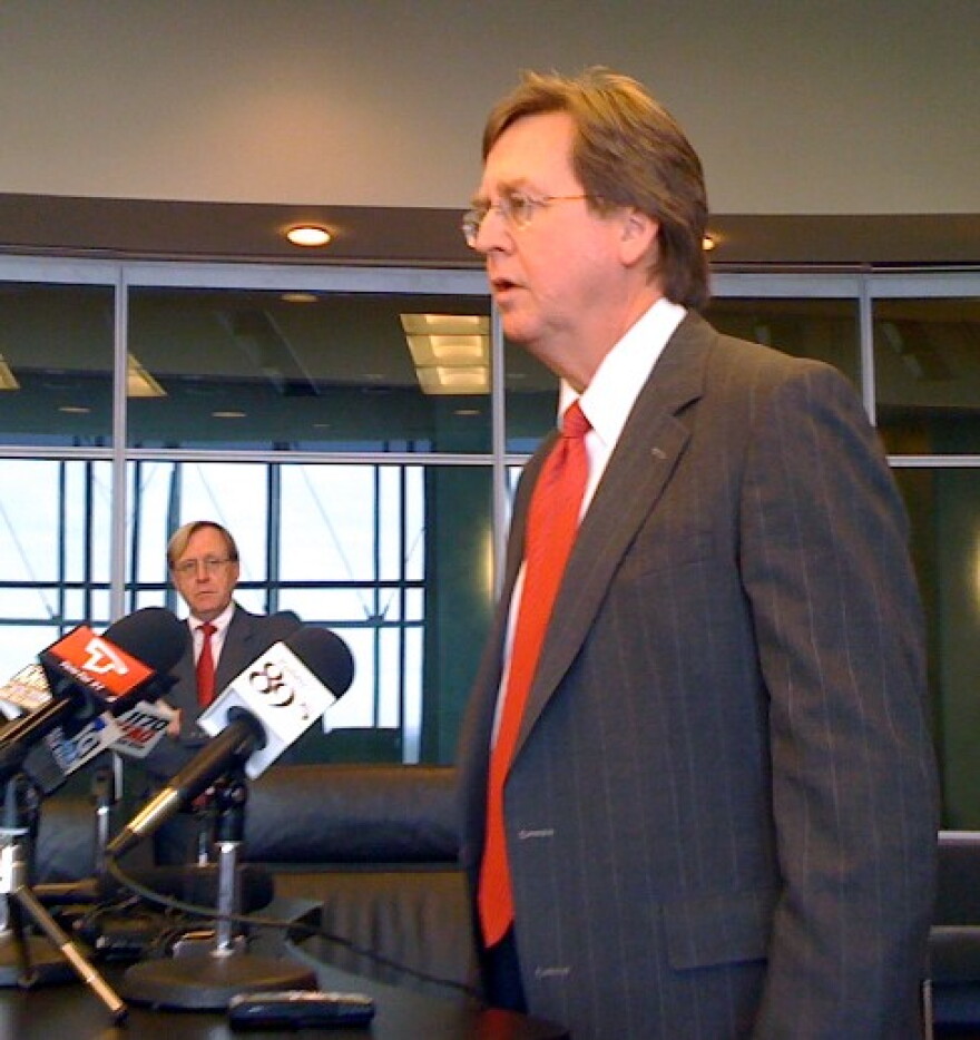 Mayor Bartlett announces budget cuts as chief-of-staff Terry Simmonson watches.