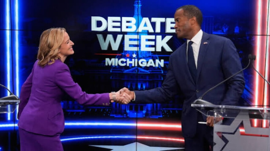 Michigan Secretary of State Jocelyn Benson and U.S. Congressman John James shake hands before gubernatorial debate in Grand Rapids