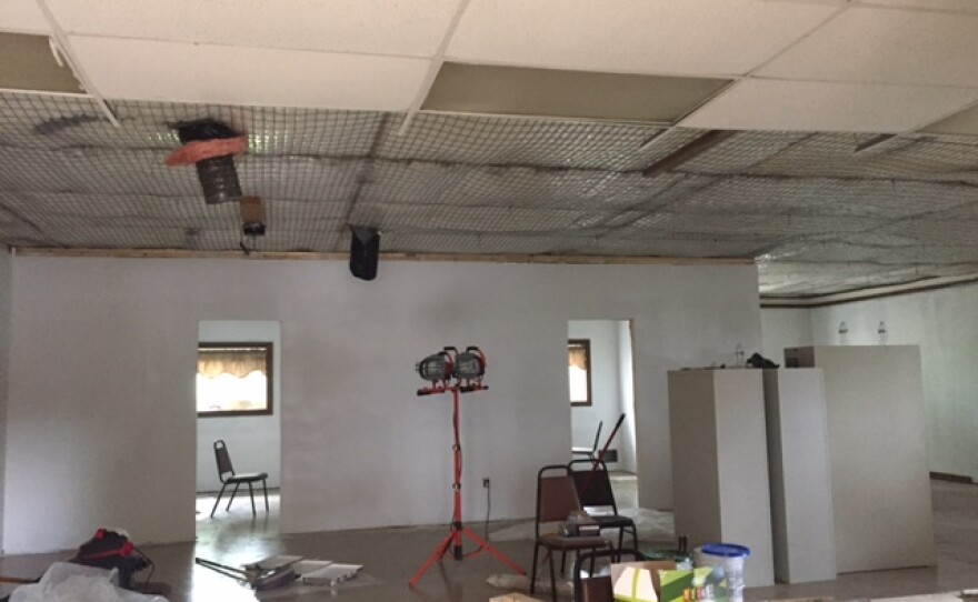 Empty room with missing ceiling tiles and two doorways inside the former Tri-Lakes banquet hall.