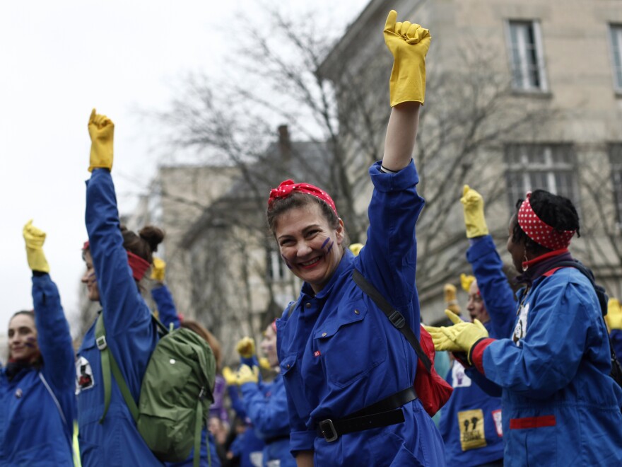 A woman laughs during a march as part of the International Women's Day in Paris Sunday.