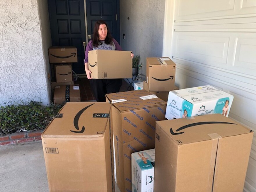 Jess Weigle, with the Conejo Community Outreach's Community Diaper Bank, deals with diapers deivered to her Newbury Park home. The home serves as the distribution point for families in Ventura County.