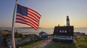 An American flag at Portland Head Light catches the light at sunrise, Wednesday, June 11, 2025, in Cape Elizabeth, Maine. (Robert F. BukatyAP)