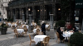 Empty tables stand at a restaurant in Manhattan. (Spencer Platt/Getty Images)