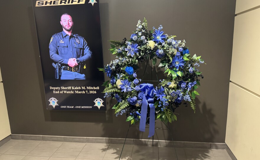 A photo of a reef and virtual sign showing an image of Deputy Sheriff Kaleb Mitchell.