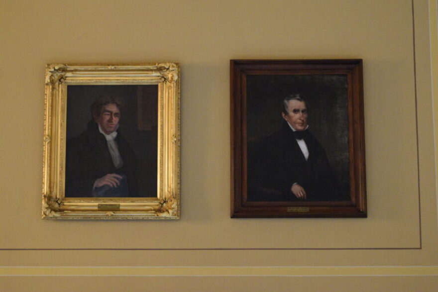 Portraits of former Gov. William Hendricks, left, and territorial Gov. William Henry Harrison hang side-by-side at the Indiana Statehouse.