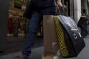 A shopper carries bags down Fifth Avenue in New York. (Julia Nikhinson/AP)