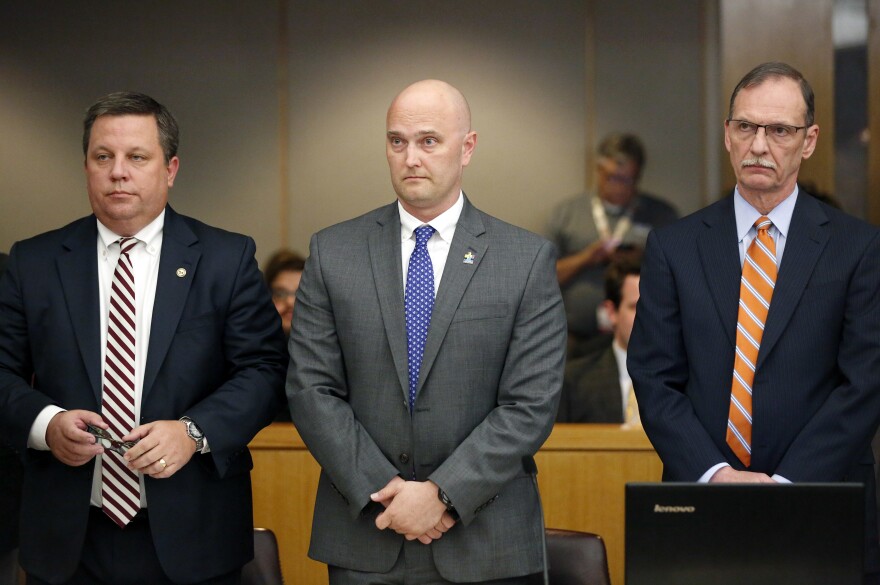 Fired Balch Springs police officer Roy Oliver, center, and his attorneys Miles Brissette, left, and Bob Gill stand before the reading of the verdict during Oliver's trial at the Frank Crowley Courts Building in Dallas on Aug. 28, 2018.