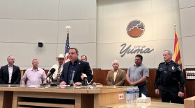 Yuma Mayor Doug Nicholls, center, speaks to reporters at Yuma City Hall hours before Title 42 is set to expire on Thursday, May 11, 2023.