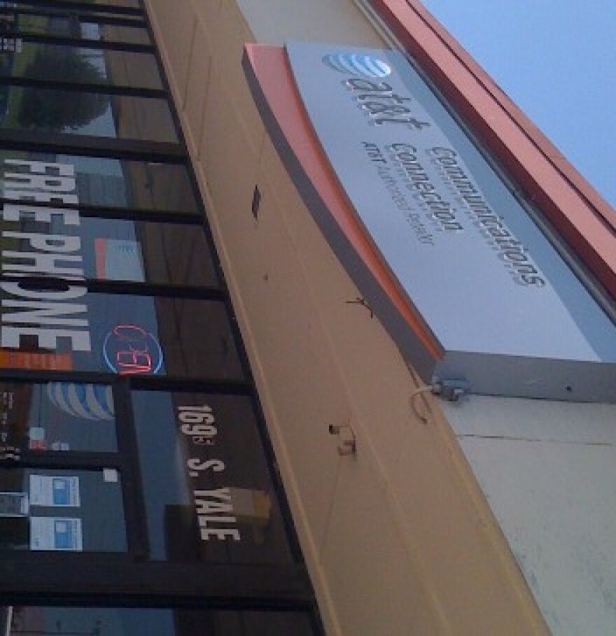 People flock to AT&T stores, like this one near 17th and Yale, to buy the new iPhone.