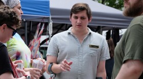 New Hampshire State Rep. Heath Howard, who is running for Congress, speaks with voters during Rochester Pride on Aug. 1, 2026.