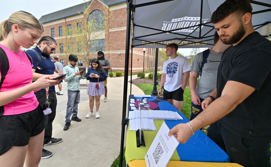 A line forms of students planning to register as bone marrow donors at the Wilkes University football teams drive.