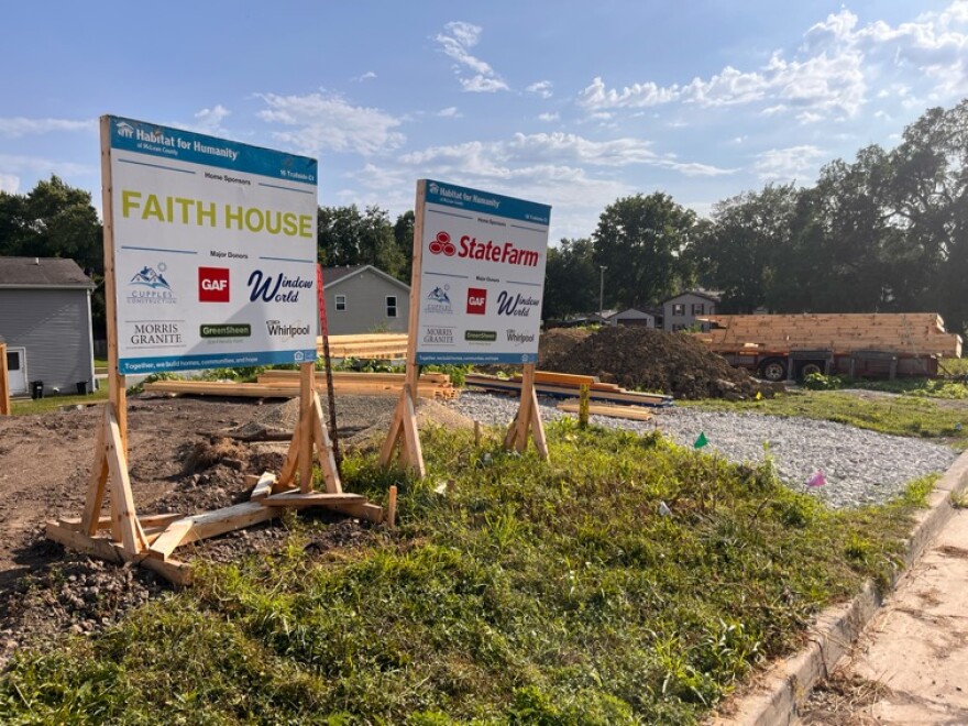 A wooden sign at a construction site
