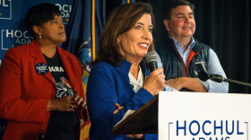 Governor Kathy Hochul speaks to a crowd, with U.S. Rep. John Mannion (NY-22) and Syracuse Mayor Sharon Owens behind her. 