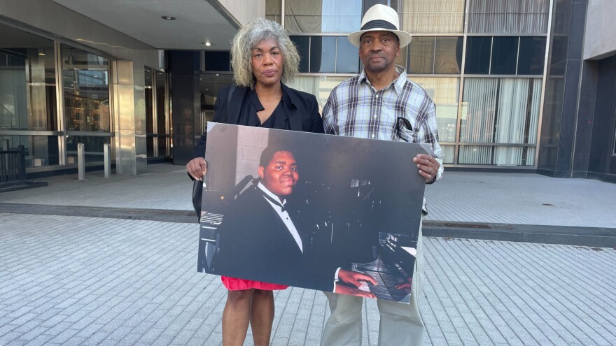 Herman Whitfield III's parents, Gladys Whitfield and Herman Whitfield II, hold a picture of their son at a press conference on April 13, 2023.