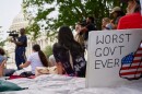 A sign saying "worst government ever" is seen by the Capitol during a rally with fired federal workers about the looming government shut down, Tuesday, Sept. 30, 2025, on Capitol Hill in Washington.