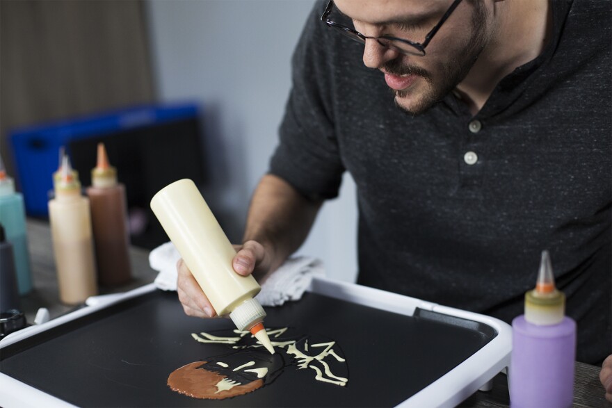 Daniel Drake creates pancake art using a grill from Dancakes' griddle kit.