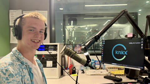DJ Ross Gawthrop behind the microphone in the KNKX studios.