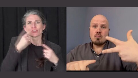 One woman and one man in the midst of doing sign language interpretation