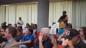 Knox County residents hold up signs opposing automatic license plate readers during a public workshop on August 24, 2026.