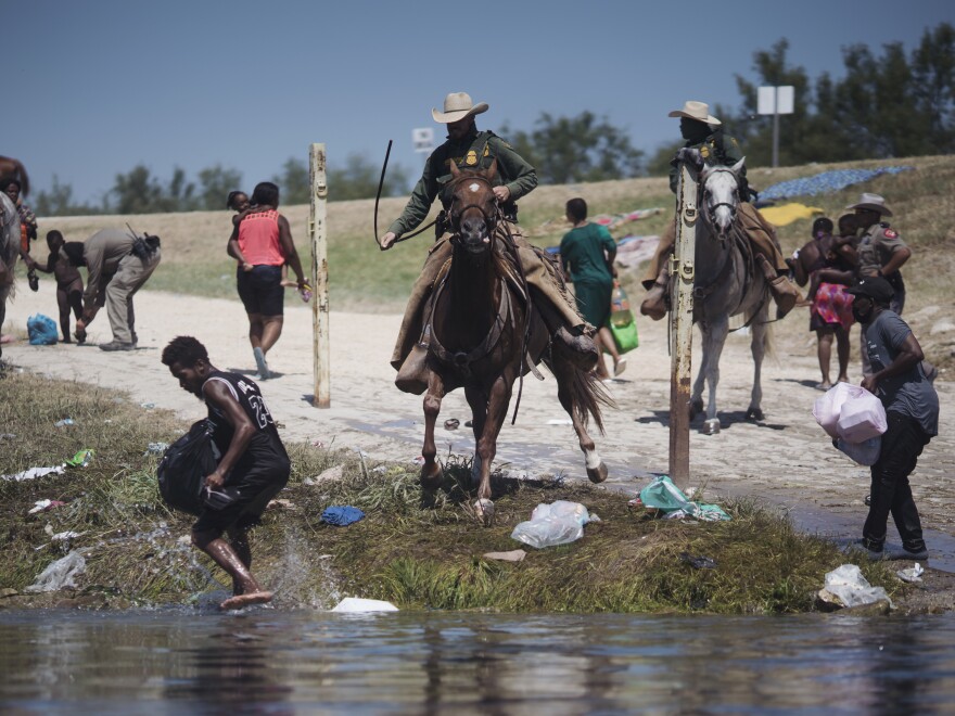 U.S. Border Patrol agents confront migrants crossing the Rio Grande near the Del Rio-Acuña Port of Entry in Del Rio, Texas.