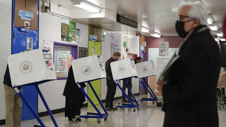 Voters fill in their ballots at a polling place in New York, Tuesday, Nov. 2, 2021. On Tuesday, Nov. 2, 2021. voters in New York backed a right to clean air and water, as one of among roughly two dozen statewide ballot measures considered by voters across the U.S. (AP Photo/Seth Wenig)