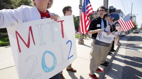 Supporters cheer at passing cars outside the venue as Republican presidential candidate Mitt Romney speaks at a campaign stop at Lansing Community College May 8, 2012 in Lansing, Michigan.