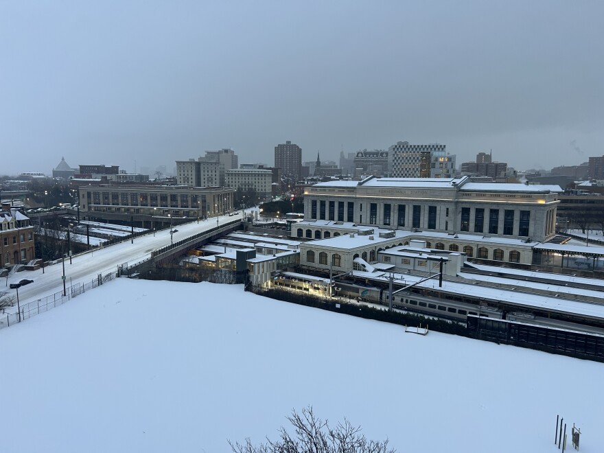 A train leaves a snow covered Penn Station in Baltimore on Sunday, January 25, 2026.
