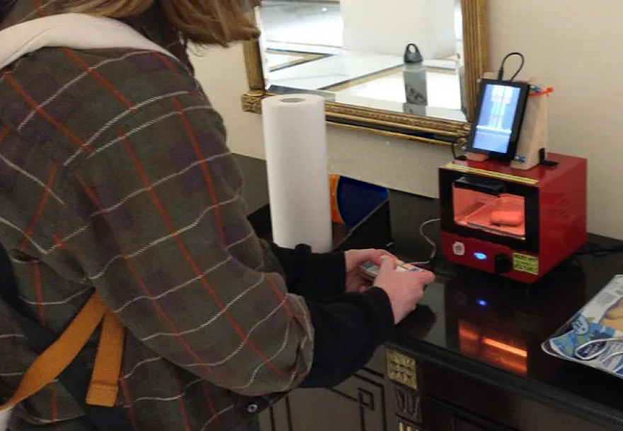 A user interacts with 'Playzing,' a gaming console drilled into a toaster.