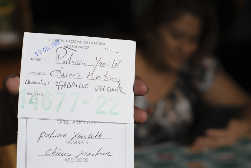 Transgender man Fabricio Chicas holds his Women’s National Hospital user card, filled out with his given name, Patricia Yamileth Chicas Martinez, during an interview in his home in San Salvador, El Salvador, Sunday, April 30, 2023. In hospitals, Chicas said, nurses have made fun of him. Since Chicas still requires gynecological consultations, health personnel often call him by the female name on his ID or have delayed his appointments, claiming that they cannot treat “people like him.”