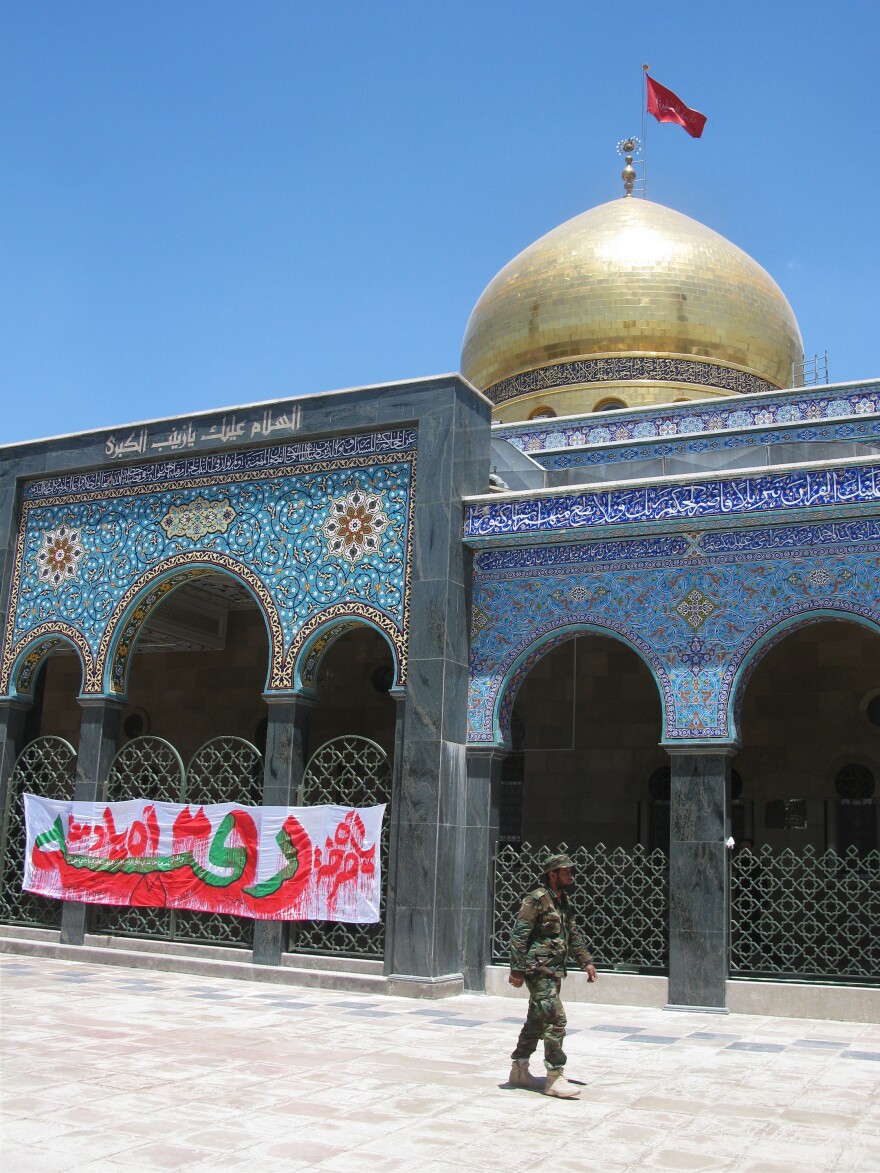 A Syrian soldier walks past the shrine, which is guarded by forces loyal to President Bashar Assad.