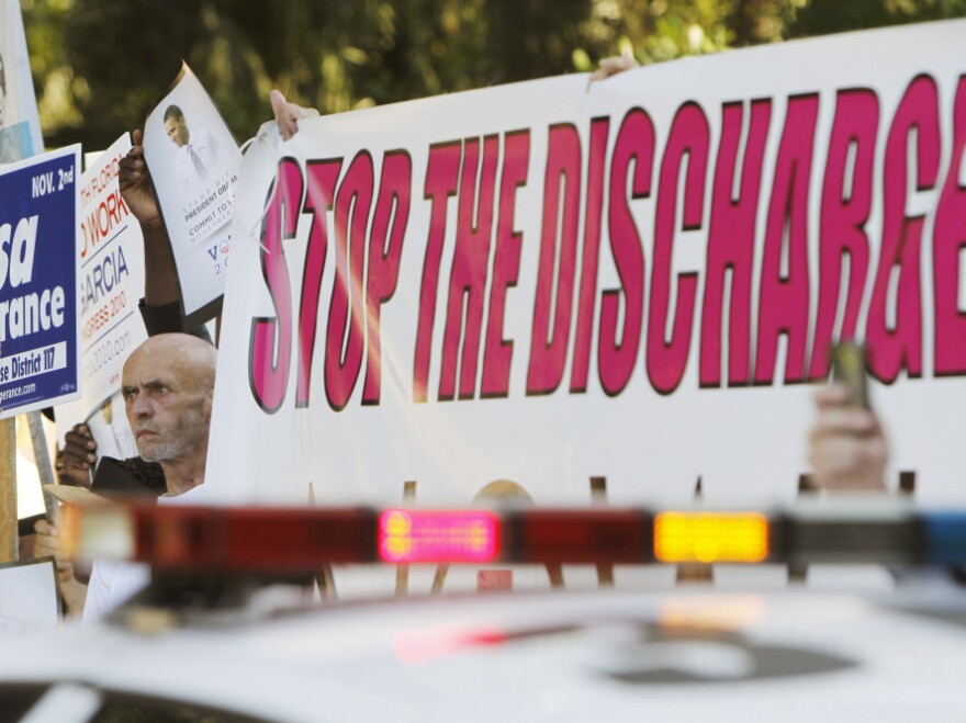 Larry Whitt, who served 12 years in the Navy before leaving because he is gay, protests the "don't ask, don't tell" policy as President Obama arrives in Coral Gables, Fla., on Oct. 11.