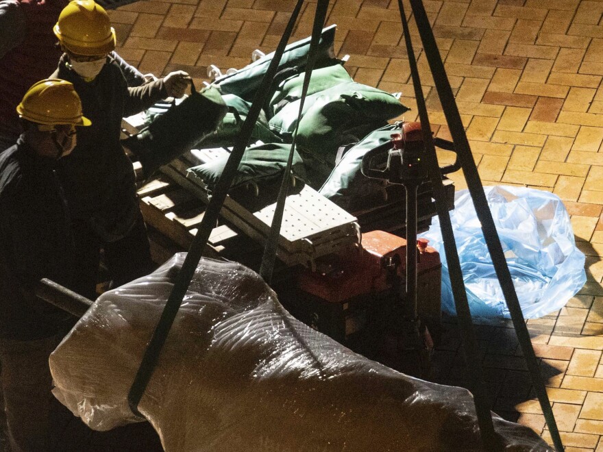 The "Pillar of Shame" statue, a memorial for those killed in the 1989 Tiananmen crackdown, is removed from the University of Hong Kong, Thursday, Dec. 23, 2021.