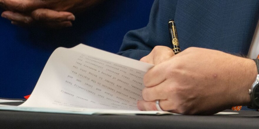 Gov. JB Pritzker signs a bill into law. 